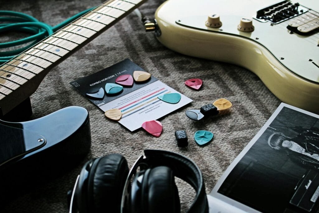 Essential guitar accessories including tuner, capo, strings, picks, and guitar strap